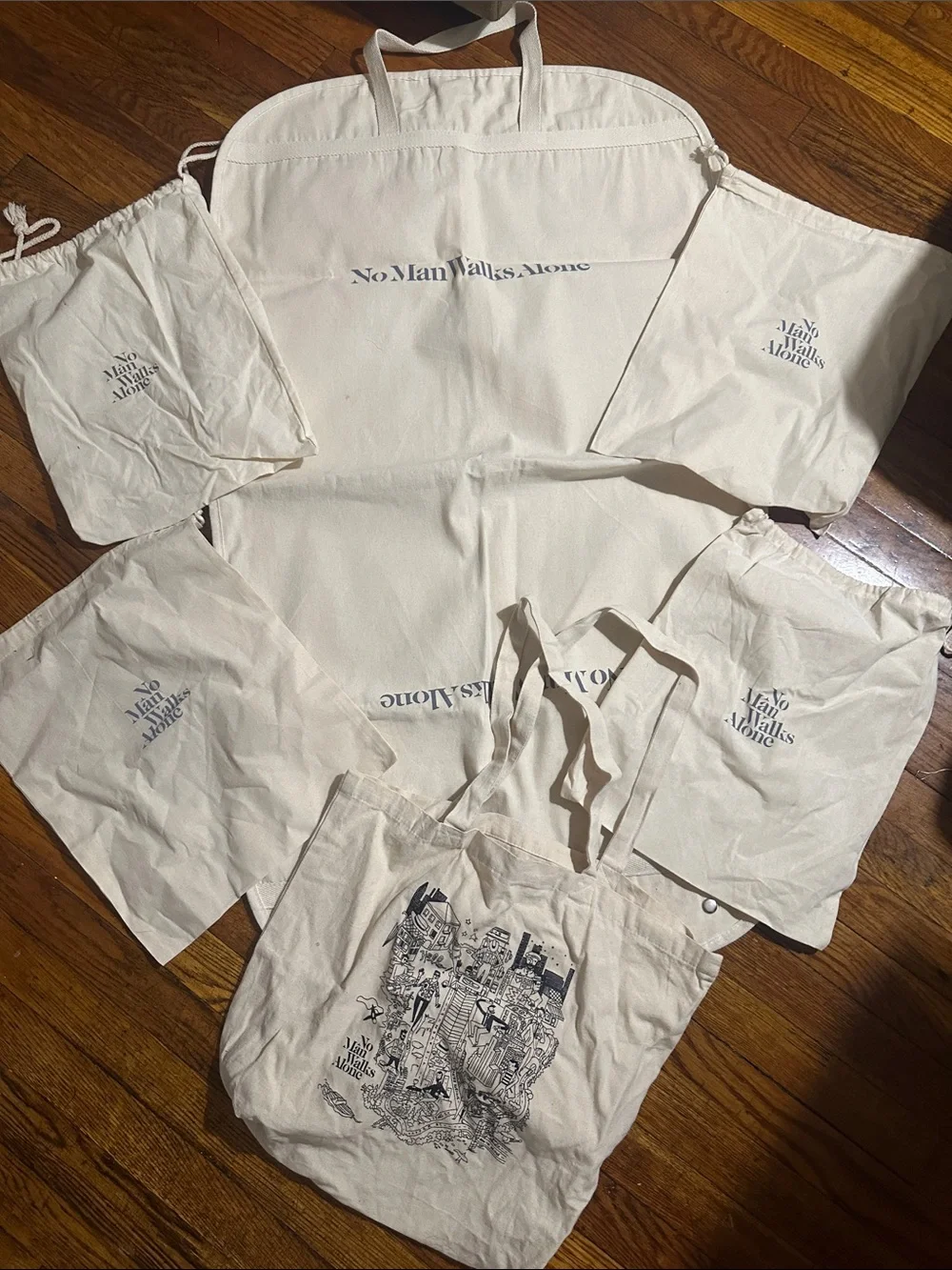 No Man Walks Alone Cream Canvas Tote Bag, Garment Bag, and 4 Dust Bags